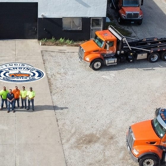 The Lansing Dumpster Co yard from above, with the trucks, containers and crew